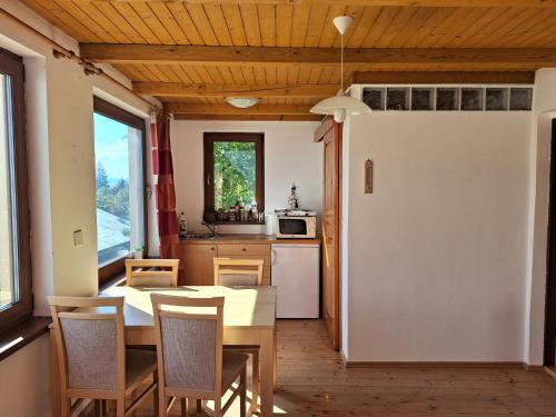 uma cozinha com uma mesa e cadeiras e um frigorífico em Sunset House Piestany Bungalow em Banka