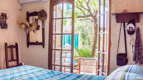 a bedroom with a bed and an open window at El Quincho de Susana y Victor in Guaymallen