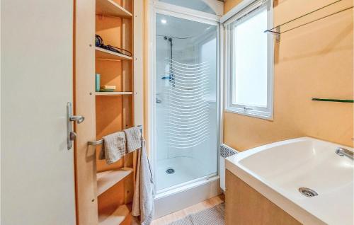 a bathroom with a tub and a sink and a shower at Stunning Caravan In Hyres With Wifi And 3 Bedrooms in Hyères