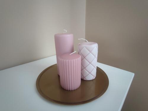 two pink candles sitting on top of a table at APARTAMENTO GAEL- PLAZA ESPAÑA in Avilés