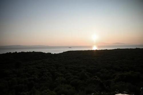 a view of the sun setting over the water at Anastasias Villa in Kastro Kyllini