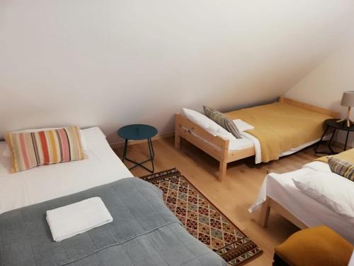 um quarto com duas camas, um sofá e uma mesa em L&B House em Malbork