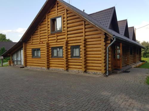 a log cabin with a gambrel roof at Upeslīči atpūtai in Jelgava