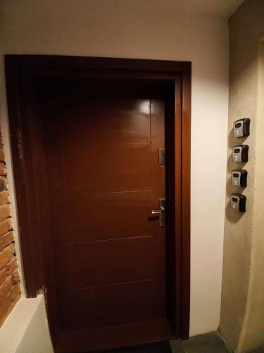 a brown door in a room with a wall at Apartamenty na Rynku Tarnów in Tarnów