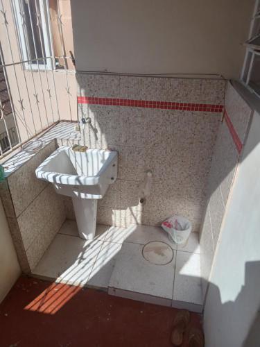a bathroom with a sink and a toilet at Hostel Leonardo Quarto com cama de casal in Vitória