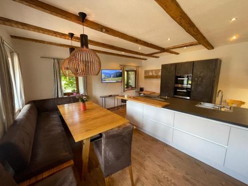a kitchen and living room with a couch and a table at Das Glaagut - Familie Hain in Hochfilzen