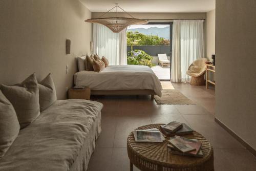 a bedroom with a bed and a couch and a living room at Suites 23 in Cassis