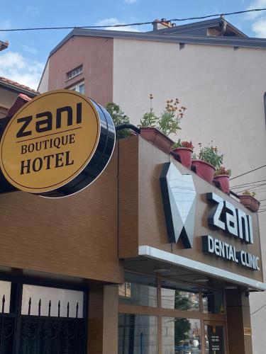 a zm boutique hotel sign on the side of a building at Zani Boutique Hotel in Prizren
