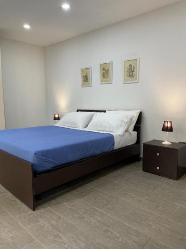 a bedroom with a large bed and two night stands at Casa vacanze Piedigrotta in Pizzo