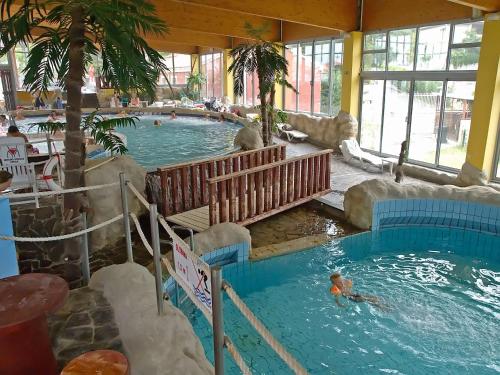 a pool in a resort with a person in the water at Apartment Sunny Days in Koper