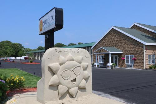 a monument in front of a building with a sign at Sunbird Cape Cod Annex in West Yarmouth