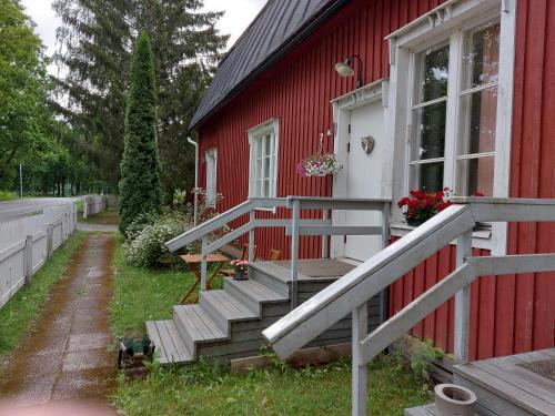a red house with stairs on the side of it at Matildan Riihi in Mathildedal