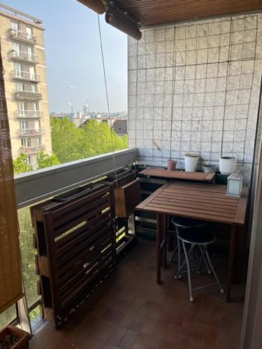 une petite cuisine avec une table et une fenêtre dans l'établissement Terrasse avec vue, proche Bercy-Paris, 3 pièces spacieux et confort, à Paris