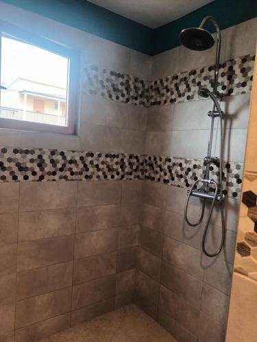 a bathroom with a shower with a glass door at Au chant des mandarins 2 gites de 15 personnes et un 3ème gite à proximité de 12 in Charmes
