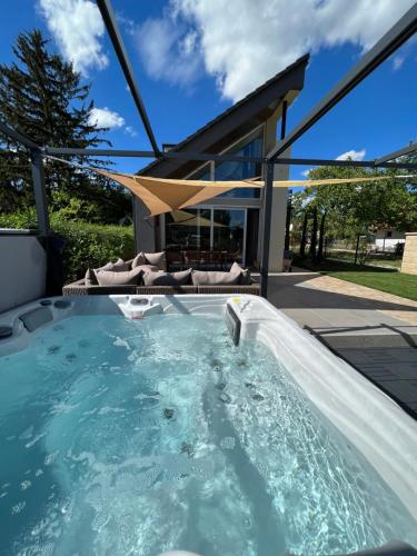 a hot tub in the backyard of a house at Beige Villa Balatonkenese in Balatonkenese