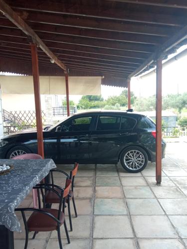 a black car parked under a pavilion at Savvinio Country Apartment in Alexandroupoli