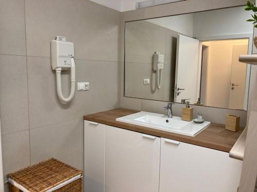 a bathroom with a sink and a mirror at Casa di Giorgio in Jelsa