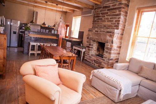 a living room with a couch and a fireplace at Paradijs in Nieu-Bethesda in Nieu-Bethesda