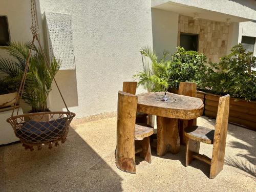 a wooden table and two benches and a table and chairs at Kinneret View in Kinneret