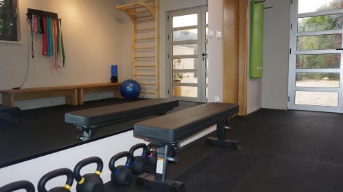 a room with a gym with a bench and weights at Luxury Aparthotel Zadar in Zadar