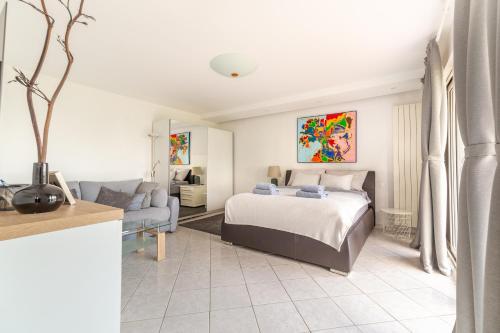 a bedroom with a bed and a living room at Villa Bellavista I in Portorož