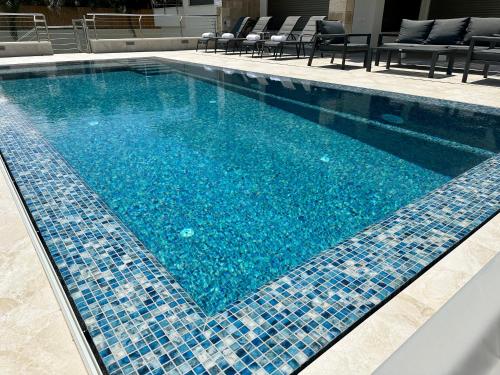 a swimming pool with blue tiles on it at Kinneret View in Kinneret