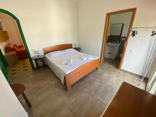 a bedroom with a bed and a large mirror at DesyMar Inn in Fontane Bianche