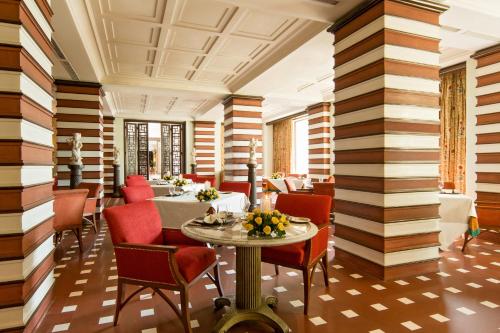 a restaurant with striped walls and a table and chairs at The Oberoi Amarvilas Agra in Agra