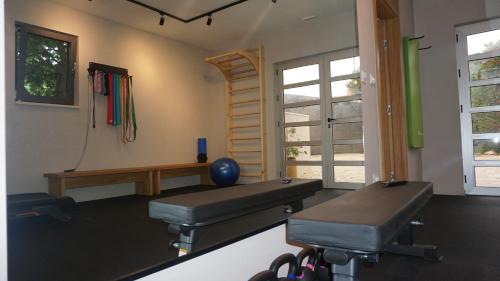 a room with a gym with two chairs and a table at Luxury Aparthotel Zadar in Zadar