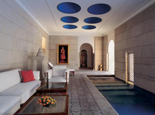 a living room with a white couch and blue ceilings at The Oberoi Amarvilas Agra in Agra