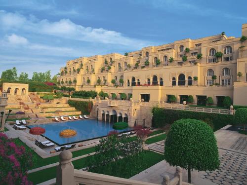 a large building with a pool in front of it at The Oberoi Amarvilas Agra in Agra