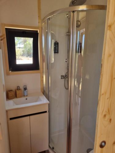 a bathroom with a shower and a sink at Eco Lodge Villa das Alfarrobas com Piscina in Algoz