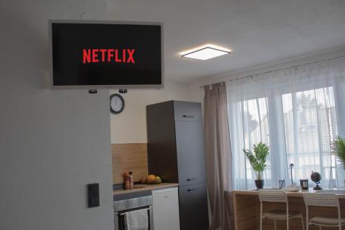 a sign on the wall of a kitchen with a table at Modernes Studio mit großem Balkon, vollausgestatteter Küche und idealem Arbeitsplatz für Home Office in Gärtringen