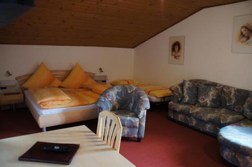 a living room with a couch and a couch and a living room with a bed at Oberangerhof in Lagundo