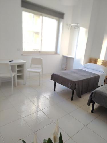 a bedroom with two beds and a table and chairs at NICE STAY in Naples