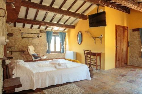 a bedroom with a white bed in a room at Agriturismo Dai Du Bourdei in Frontino