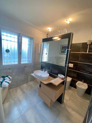 a bathroom with a sink and a toilet and a mirror at Tra campagna e mare in Lido delle Nazioni