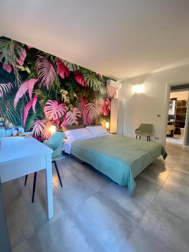 a bedroom with a bed with a colorful wall at Tra campagna e mare in Lido delle Nazioni