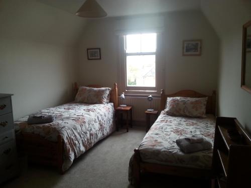 a bedroom with two beds and a window at Rowlands Castle No 41 in Rowlands Castle
