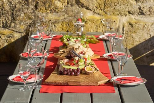 a table with a plate of food and wine glasses at Landhotel Brauner Hirsch in Kammerforst