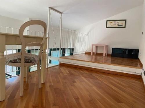 a living room with a chair and a table at Casa Roma Arenzano in Arenzano