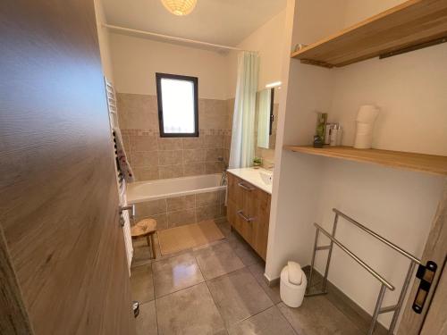 a bathroom with a tub and a sink and a toilet at Villa en Provence in Saint-Saturnin-lès-Apt