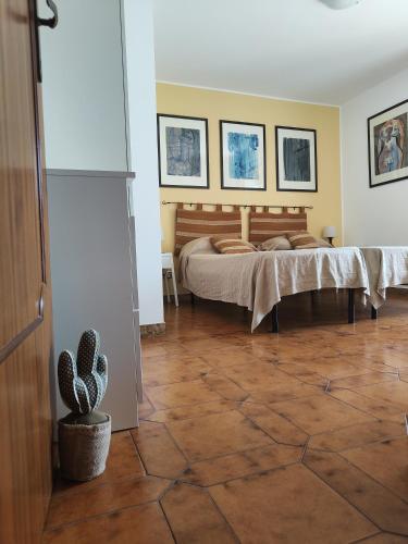 a bedroom with a bed and a cactus at Casa Parco Aranci in Formia