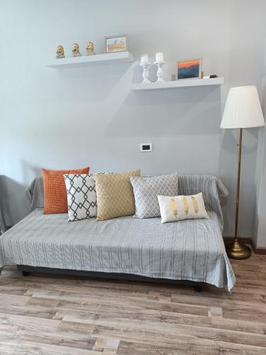 a couch in a living room with pillows on it at Decò & Retrò apartment in La Spezia