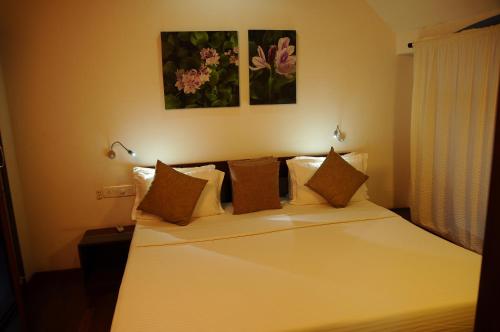 a bedroom with a bed with white sheets and pillows at Xandari Riverscapes in Alleppey