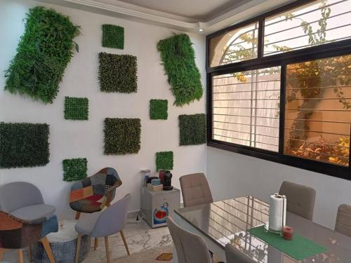 a room with a wall covered in green plants at Keurgui La Maison in Gandigal