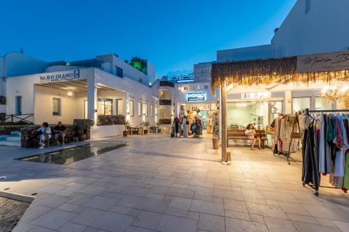a street in a town with shops and buildings at Naxos Island Hotel in Agios Prokopios