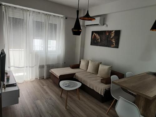 a living room with a couch and a table at Apartman ELENA in Jagodina