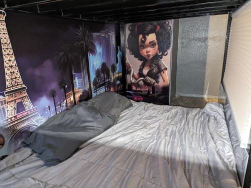 a bed with a painting of the eiffel tower at Shared living NOT A HOTEL in Phoenix