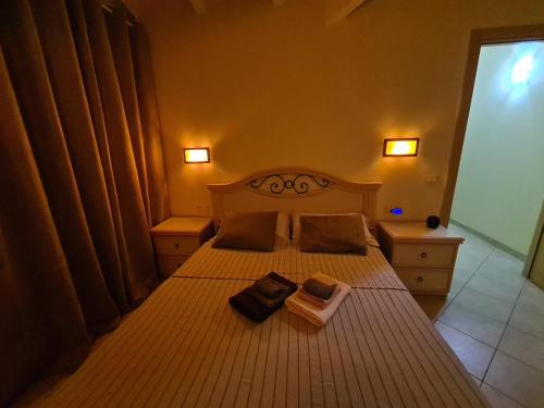 a bedroom with a bed with two books on it at Plaza Top floor apartment in Santa Maria